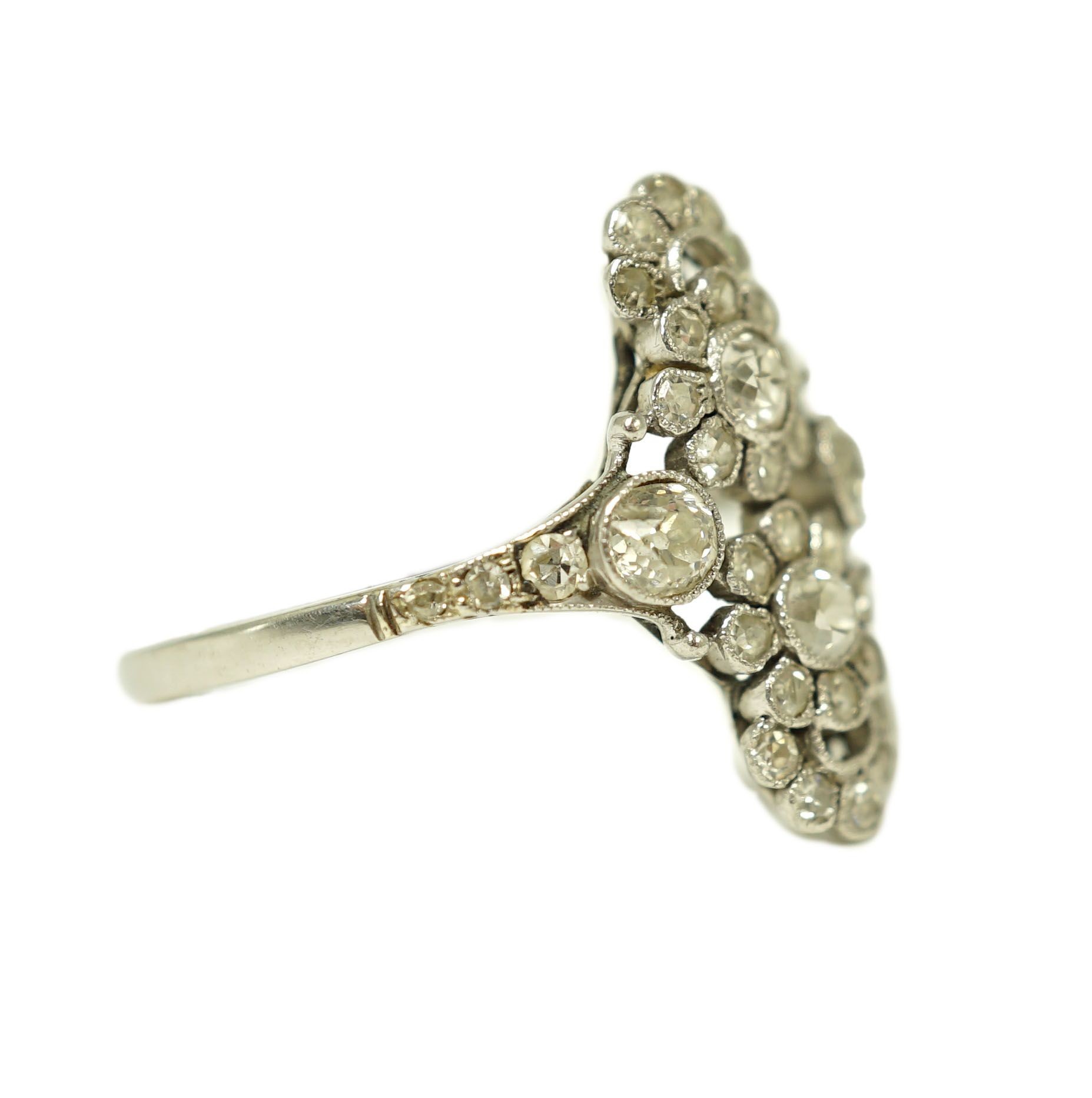 A 1920's platinum and millegrain diamond set flower head cluster upfinger ring
